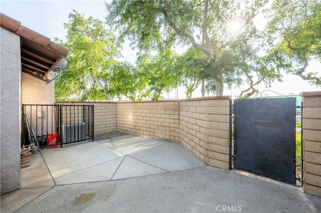 view of patio featuring fence and a gate