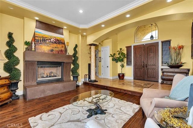20711 Canyon Rd, Los Banos, CA 93635 - living area with wood finished floors, recessed lighting, a lit fireplace, ornamental molding, and decorative columns