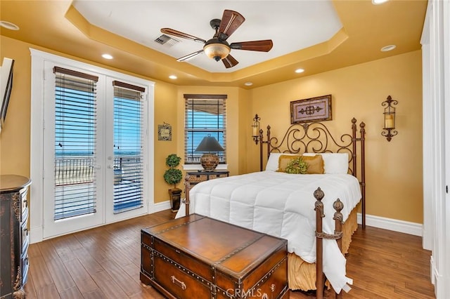 20711 Canyon Rd, Los Banos, CA 93635 - bedroom featuring wood finished floors, a raised ceiling, baseboards, access to exterior, and recessed lighting