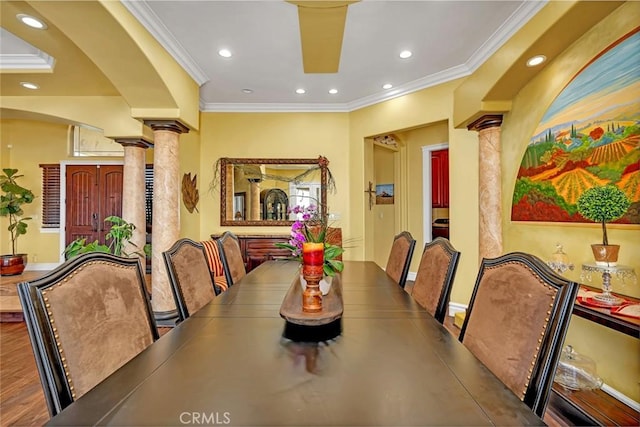 20711 Canyon Rd, Los Banos, CA 93635 - dining area featuring recessed lighting, wood finished floors, arched walkways, crown molding, and decorative columns