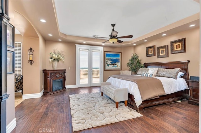 20711 Canyon Rd, Los Banos, CA 93635 - bedroom with recessed lighting, a raised ceiling, access to exterior, baseboards, and hardwood / wood-style flooring