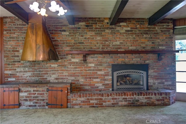 unfurnished living room featuring a chandelier, wood ceiling, carpet floors, a fireplace, and beam ceiling