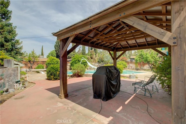 view of patio / terrace featuring a fenced in pool, a gazebo, grilling area, and fence