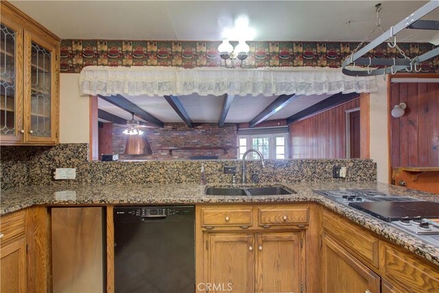 kitchen with light stone counters, a sink, beamed ceiling, black dishwasher, and tasteful backsplash