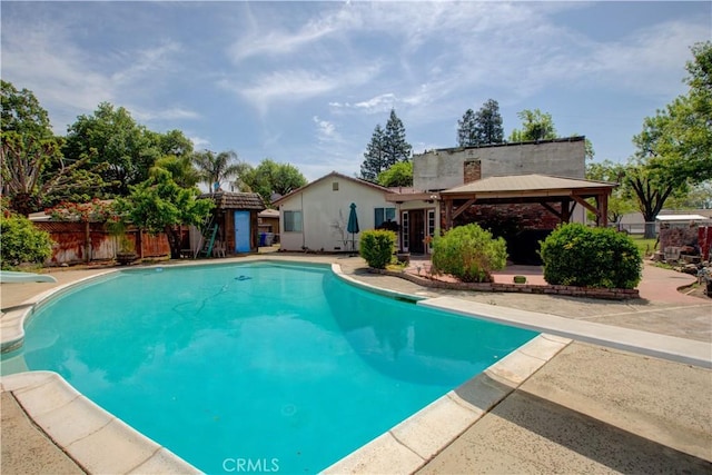 view of pool with a fenced in pool, a gazebo, a water slide, fence, and a diving board