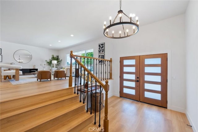 3130 E Craig Dr, Orange, CA 92869 - foyer entrance with wood finished floors, a chandelier, stairs, baseboards, and recessed lighting