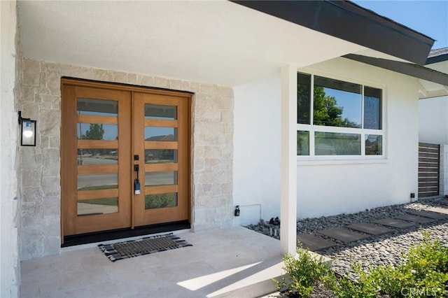 3130 E Craig Dr, Orange, CA 92869 - view of exterior entry with french doors, stucco siding, and stone siding