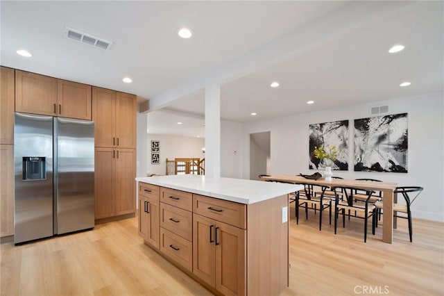 3130 E Craig Dr, Orange, CA 92869 - kitchen featuring stainless steel fridge, light wood-style flooring, recessed lighting, a center island, and beam ceiling