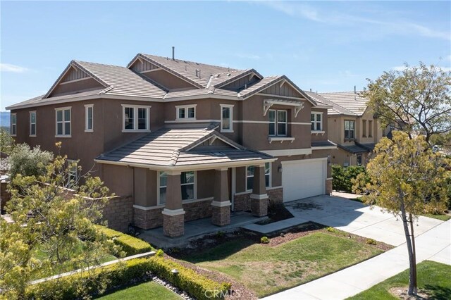 22364 Driftwood Ct, Saugus, CA 91350 - view of front of property featuring a tile roof, stucco siding, stone siding, and covered porch
