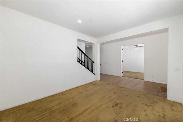 22364 Driftwood Ct, Saugus, CA 91350 - empty room featuring baseboards, ceiling fan, stairway, tile patterned floors, and carpet flooring