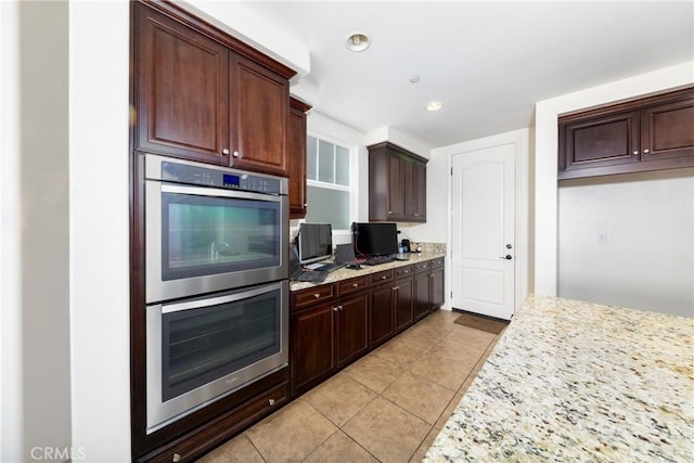 22364 Driftwood Ct, Saugus, CA 91350 - kitchen featuring light tile patterned floors, dark brown cabinetry, recessed lighting, light stone counters, and stainless steel double oven