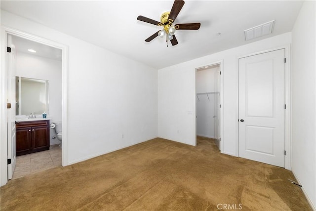 22364 Driftwood Ct, Saugus, CA 91350 - unfurnished bedroom with a closet, light carpet, a spacious closet, ensuite bath, and visible vents