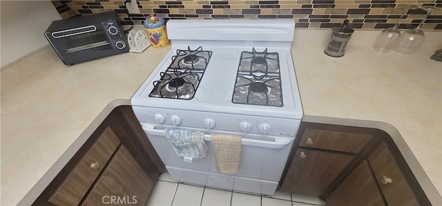 643 W Villa Chaparral Rd, San Jacinto, CA 92583 - details featuring a toaster, decorative backsplash, and white range with gas stovetop