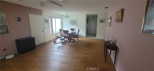 643 W Villa Chaparral Rd, San Jacinto, CA 92583 - dining space featuring visible vents, wood finished floors, and ceiling fan with notable chandelier