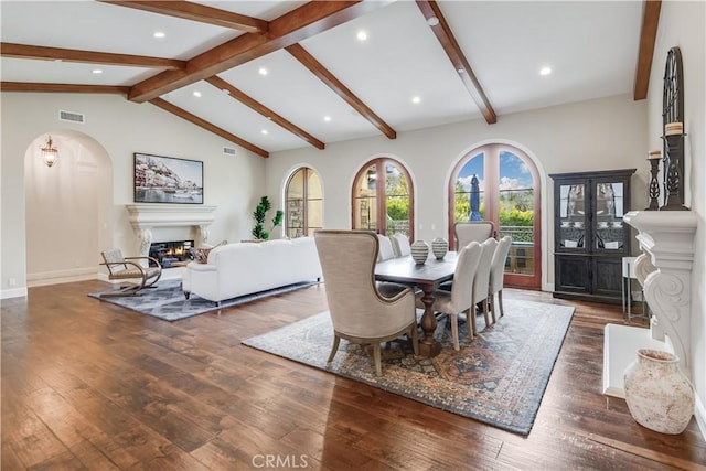 1217 Granvia Altamira, Palos Verdes Estates, CA 90274 - dining room with vaulted ceiling with beams, a glass covered fireplace, visible vents, and hardwood / wood-style flooring