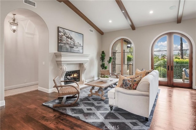 1217 Granvia Altamira, Palos Verdes Estates, CA 90274 - living area featuring arched walkways, visible vents, hardwood / wood-style floors, and lofted ceiling with beams