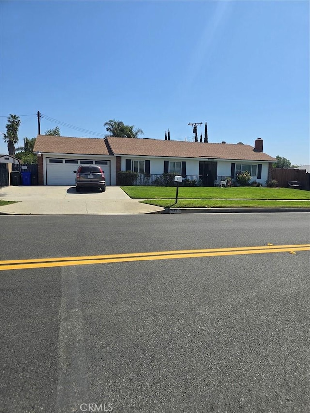 1861 N Lilac Ave, Rialto, CA 92376 - single story home featuring a garage, driveway, fence, and a front lawn