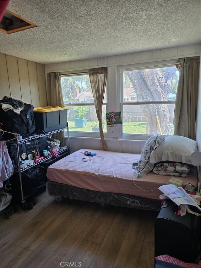 1861 N Lilac Ave, Rialto, CA 92376 - bedroom with wood walls, hardwood / wood-style flooring, and a textured ceiling