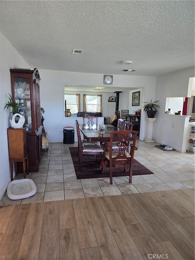 1861 N Lilac Ave, Rialto, CA 92376 - dining area featuring visible vents, light wood finished floors, and a textured ceiling