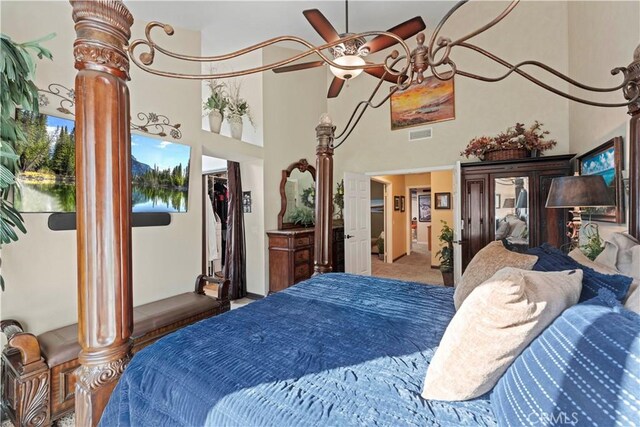bedroom featuring carpet and a high ceiling