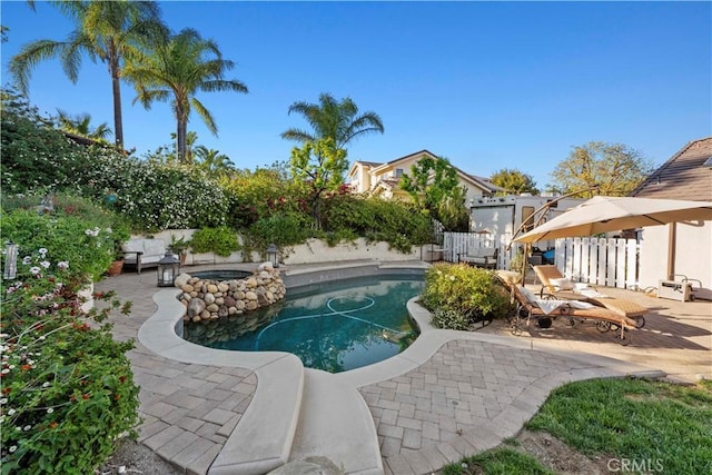 outdoor pool with a fenced backyard and a patio