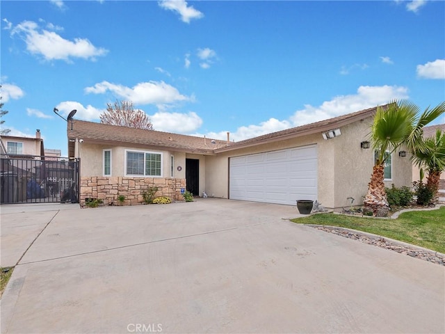 13250 Yellowstone Ave, Victorville, CA 92395 - ranch-style house with a garage, stucco siding, stone siding, and concrete driveway