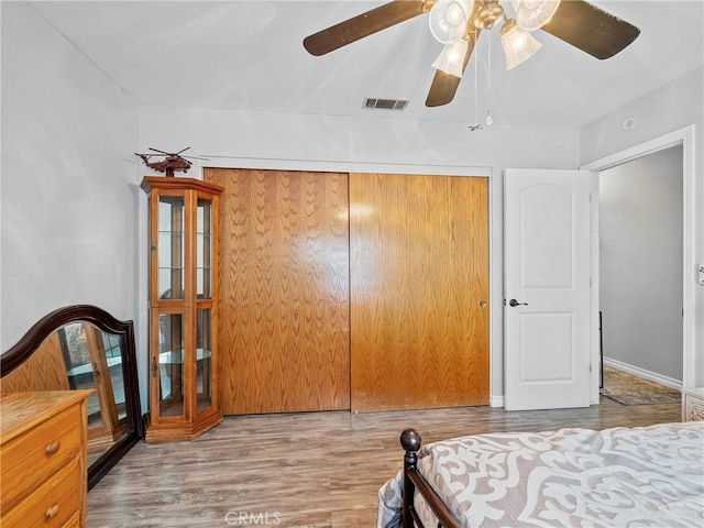 13250 Yellowstone Ave, Victorville, CA 92395 - bedroom with wood finished floors, ceiling fan, a closet, and visible vents