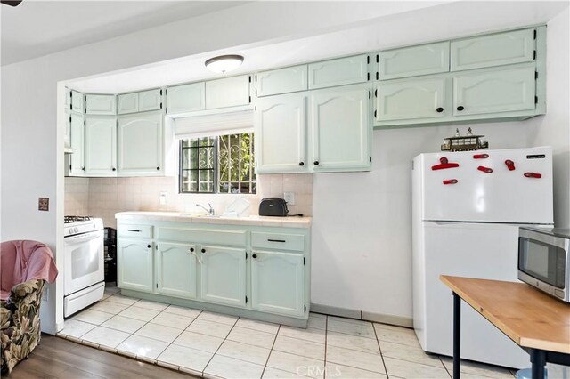 3580 Griffin Ave, Los Angeles, CA 90031 - kitchen with white appliances, tasteful backsplash, tile counters, and a sink