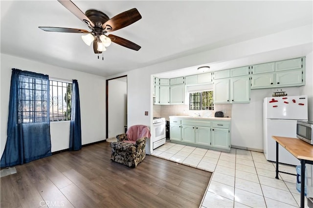 3580 Griffin Ave, Los Angeles, CA 90031 - kitchen featuring white appliances, a ceiling fan, light countertops, and healthy amount of natural light