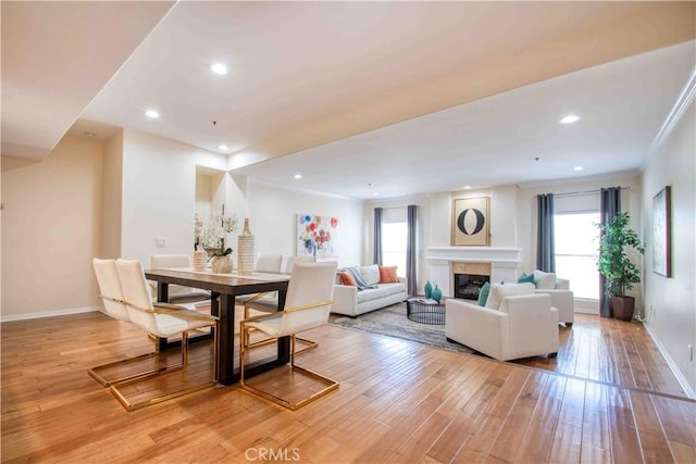 12011 Goshen Ave Unit 203, Los Angeles, CA 90049 - living room with baseboards, a glass covered fireplace, plenty of natural light, and light wood-style flooring