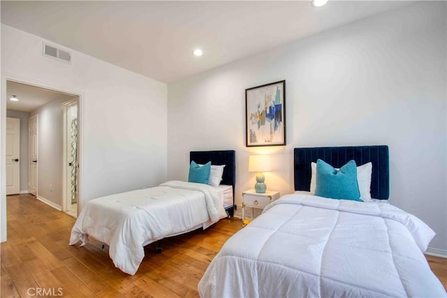 12011 Goshen Ave Unit 203, Los Angeles, CA 90049 - bedroom featuring baseboards, recessed lighting, wood finished floors, and visible vents