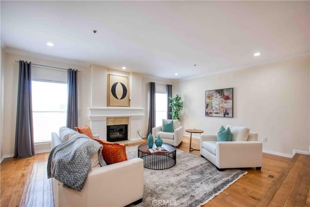 12011 Goshen Ave Unit 203, Los Angeles, CA 90049 - living area featuring a fireplace with flush hearth, ornamental molding, and light wood-style flooring