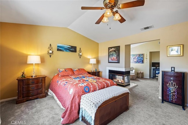 bedroom featuring ceiling fan, visible vents, carpet floors, lofted ceiling, and baseboards