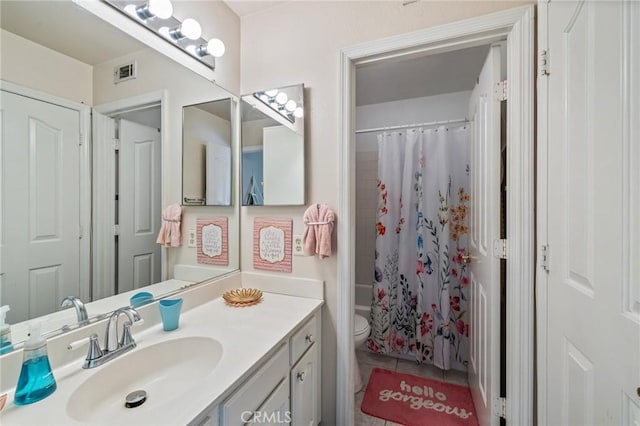 full bath featuring vanity, tile patterned flooring, toilet, visible vents, and shower / bath combo with shower curtain