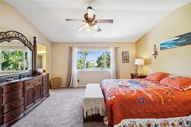 bedroom with light carpet, ceiling fan, baseboards, and lofted ceiling