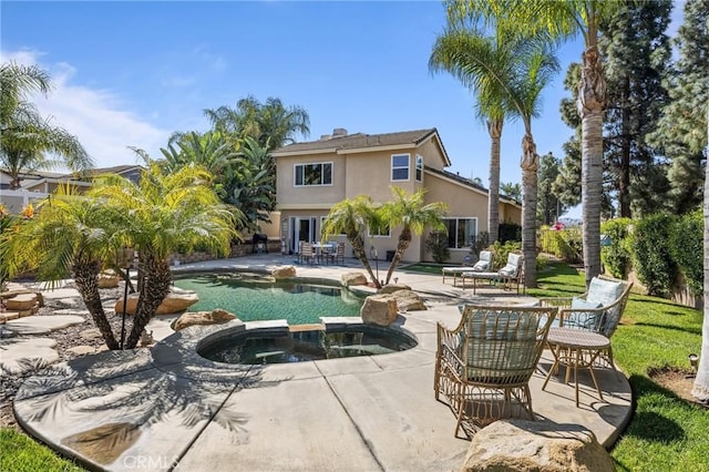 outdoor pool featuring a patio and an in ground hot tub