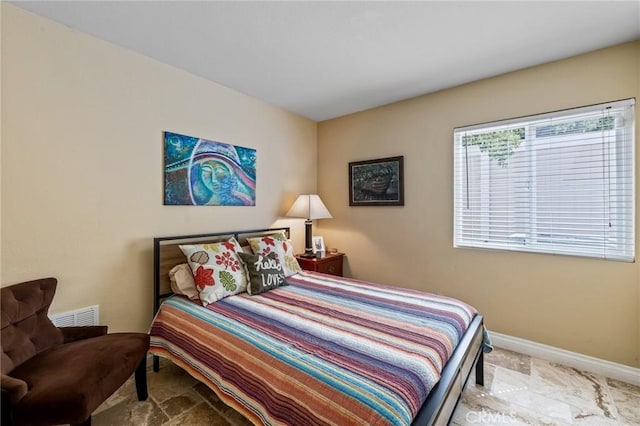 bedroom featuring visible vents and baseboards