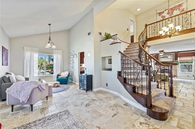 interior space featuring visible vents, baseboards, stone tile flooring, and stairway