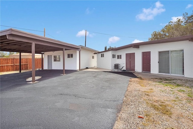 17637 Sultana St, Hesperia, CA 92345 - exterior space featuring a carport, central AC, fence, and stucco siding