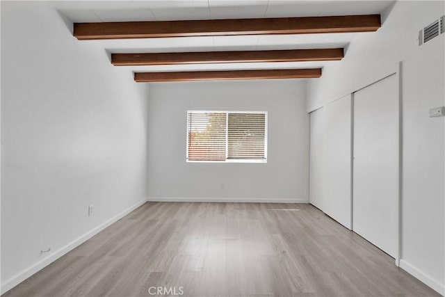 17637 Sultana St, Hesperia, CA 92345 - unfurnished bedroom featuring light wood-style floors, visible vents, baseboards, and beamed ceiling
