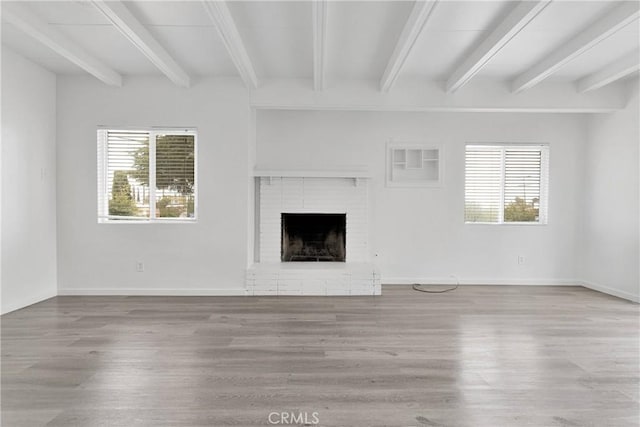 17637 Sultana St, Hesperia, CA 92345 - unfurnished living room featuring baseboards, plenty of natural light, wood finished floors, and a fireplace