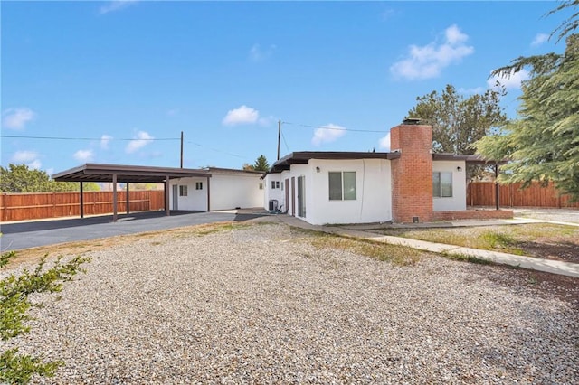 17637 Sultana St, Hesperia, CA 92345 - ranch-style house with fence, an attached carport, stucco siding, and a chimney