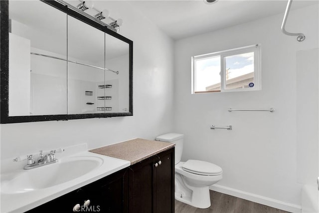 17637 Sultana St, Hesperia, CA 92345 - bathroom featuring vanity, baseboards, toilet, a shower, and wood finished floors