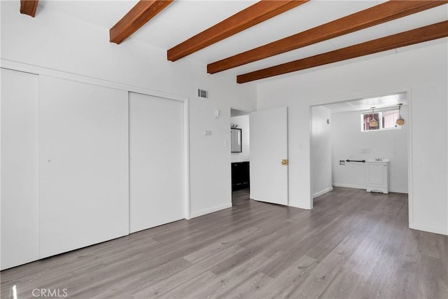 17637 Sultana St, Hesperia, CA 92345 - unfurnished living room with baseboards, wood finished floors, beam ceiling, and visible vents