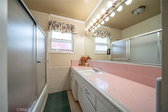 full bath featuring tile patterned floors, a wealth of natural light, vanity, and tile walls