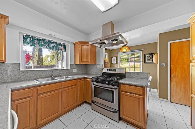 kitchen with a sink, stainless steel range with gas cooktop, marble finish floor, backsplash, and a peninsula