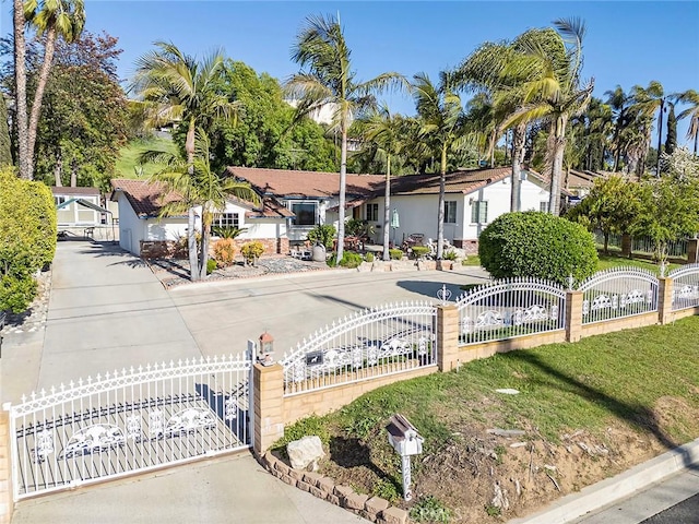 exterior space featuring a gate, a residential view, and a fenced front yard
