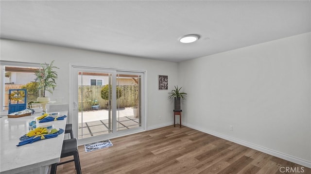 10069 Hershey Way, Riverside, CA 92503 - doorway to outside featuring wood finished floors and baseboards