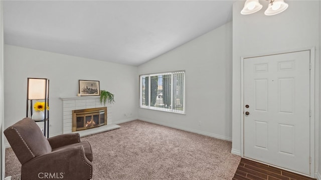 10069 Hershey Way, Riverside, CA 92503 - living area with vaulted ceiling, a fireplace, and dark wood-style floors