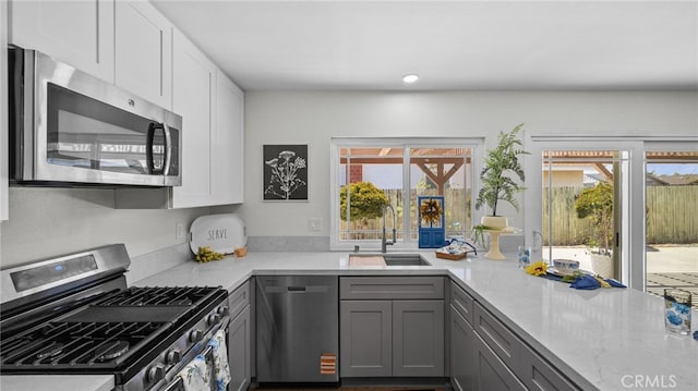 10069 Hershey Way, Riverside, CA 92503 - kitchen with appliances with stainless steel finishes, gray cabinets, light stone countertops, and white cabinets